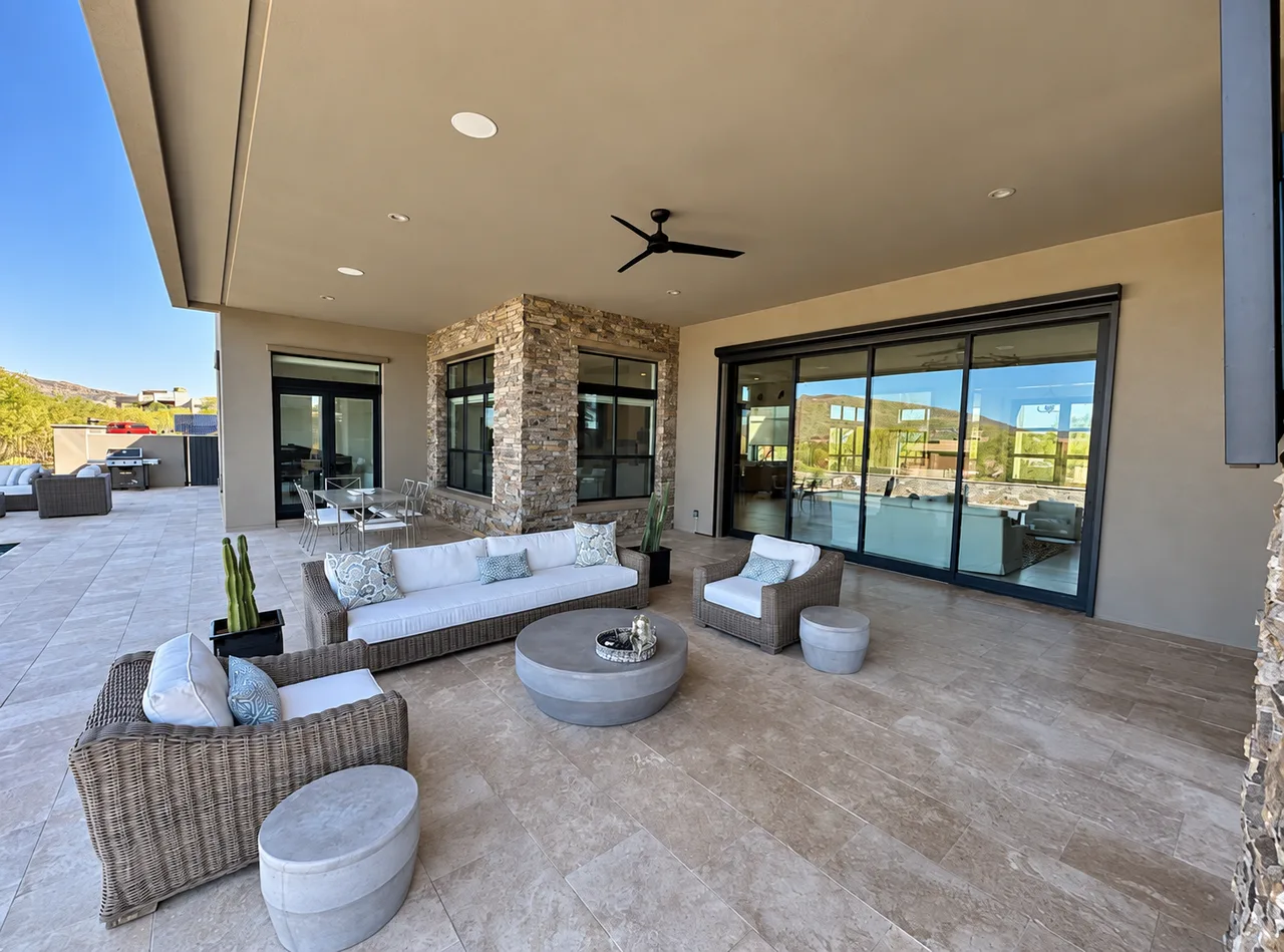Glass doors opening from a covered patio into a home